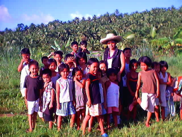 Dr. Dilodilo with some of the children in the Philippines who are benefiting from the Save the Children Campaign.